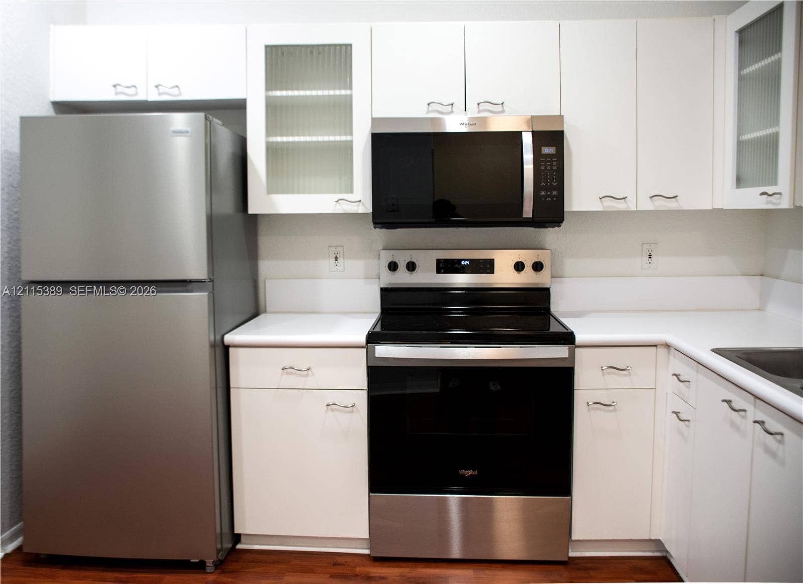 2321 Cordoba Bend, Weston, FL 33327 Kitchen featuring white cabinetry with glass-panel accents, and a full suite of stainless steel appliances