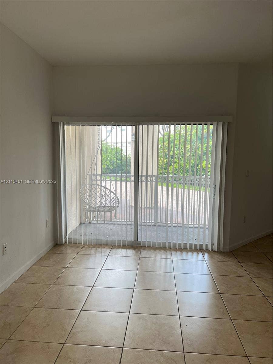 11503 NW 89th Street, #104, Doral, Doral, FL 33178 Ceramic tile flooring and sliding glass doors providing outdoor access