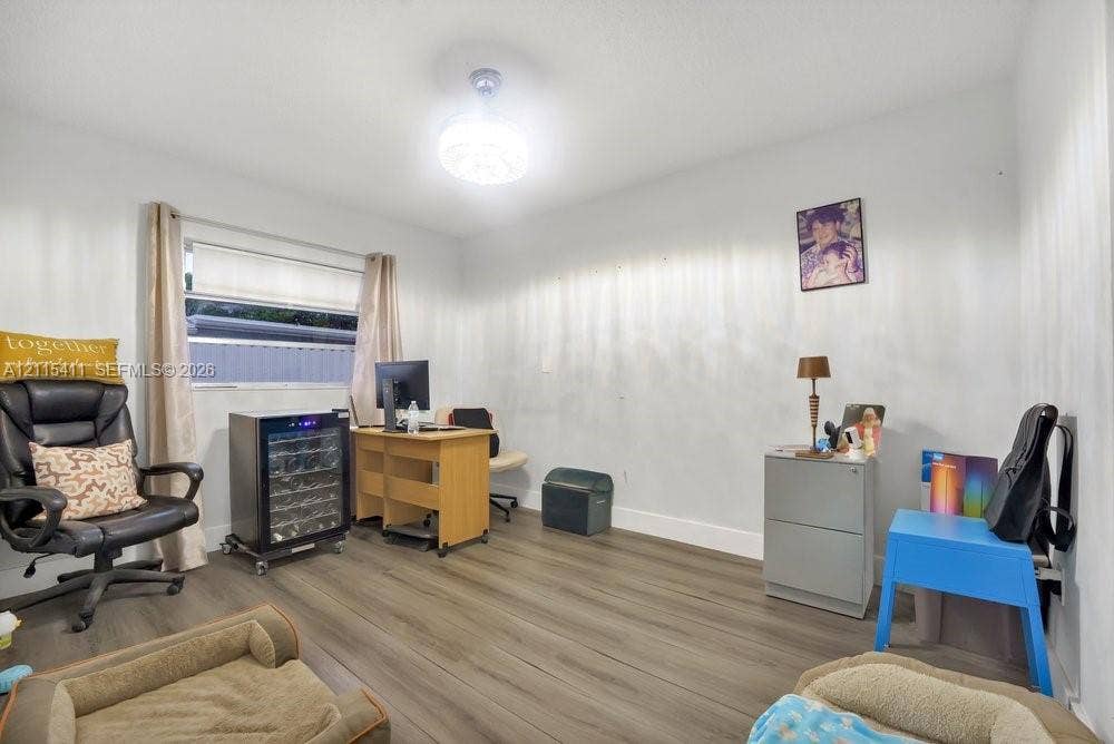 20302 NW 39th Court, Miami Gardens, FL 33055 Wood-finish flooring, horizontal window with roller shade, and ceiling-mounted light fixture