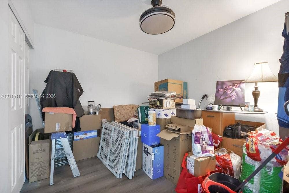 20302 NW 39th Court, Miami Gardens, FL 33055 Wood-finish flooring and a ceiling-mounted light fixture with a circular shade