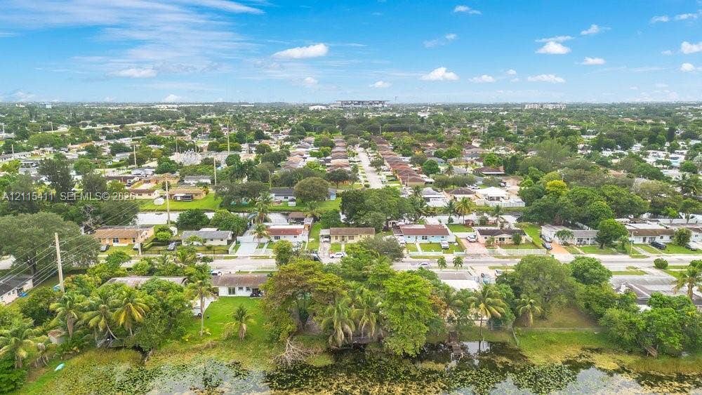 20302 NW 39th Court, Miami Gardens, FL 33055 Aerial perspective featuring a waterfront lot, mature trees, and established residential neighborhood surroundings