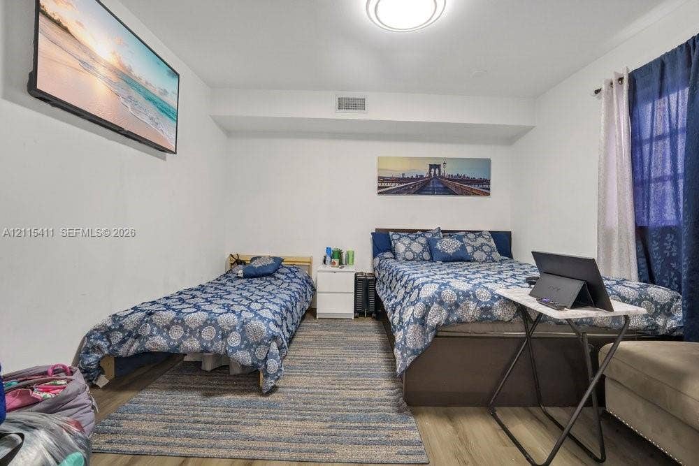 20302 NW 39th Court, Miami Gardens, FL 33055 Neutral-toned interior featuring wood-finish flooring and a flush-mount ceiling light fixture