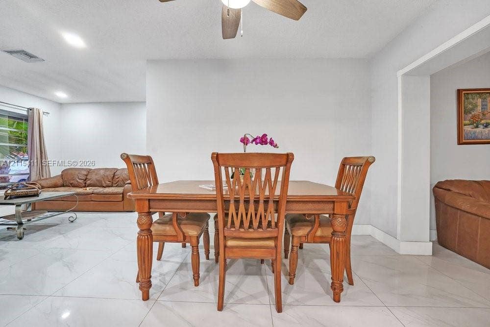 20302 NW 39th Court, Miami Gardens, FL 33055 Neutral-toned interior space featuring polished tile flooring, recessed lighting, and a ceiling fan
