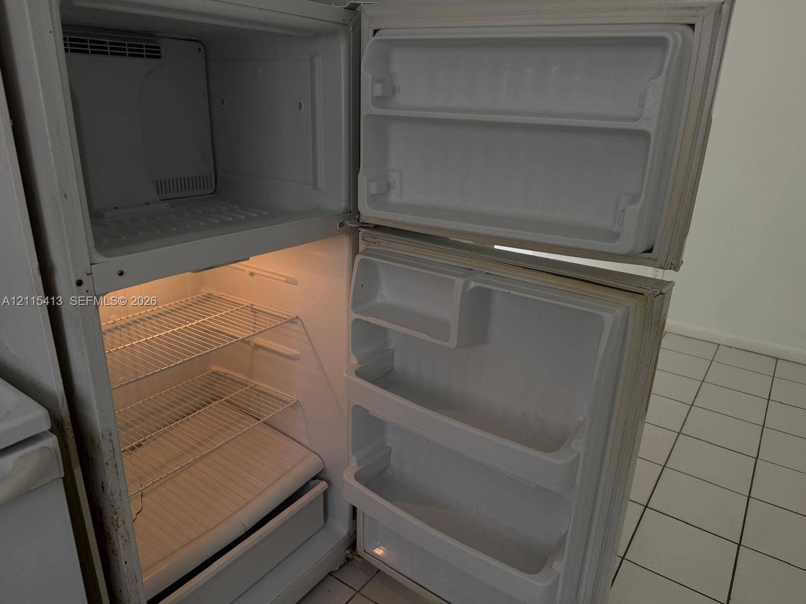 3001 NW 4th Terrace, #173, Pompano Beach, Pompano Beach, FL 33064 Top-mount refrigerator featuring wire shelving, door storage bins, and interior lighting