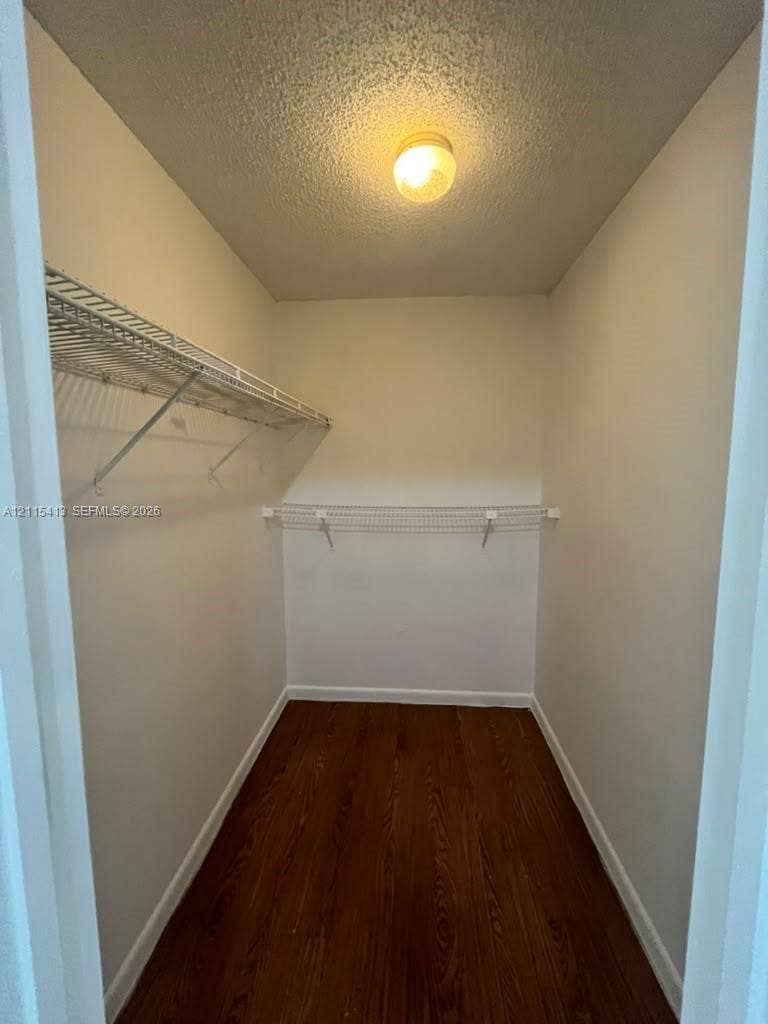 3001 NW 4th Terrace, #173, Pompano Beach, Pompano Beach, FL 33064 Storage space featuring wood-finish flooring, white walls, tiered wire shelving, and a central ceiling-mounted light fixture