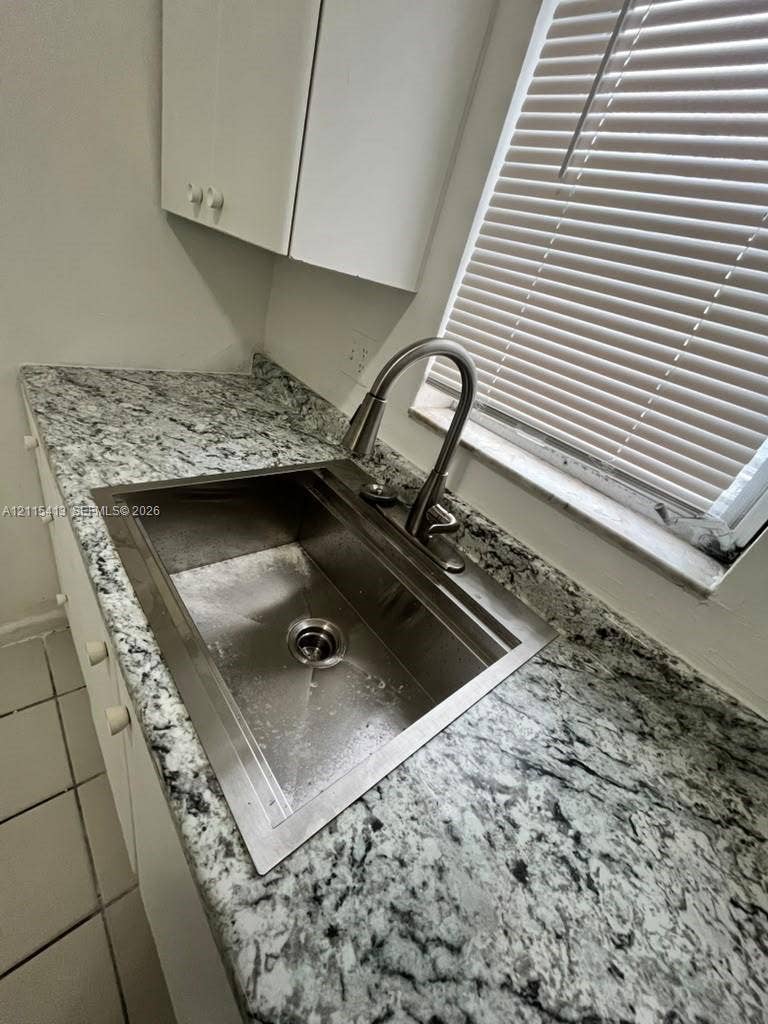 3001 NW 4th Terrace, #173, Pompano Beach, Pompano Beach, FL 33064 Stone-surface countertops paired with a deep stainless steel basin, high-arch pull-down faucet, and white cabinetry