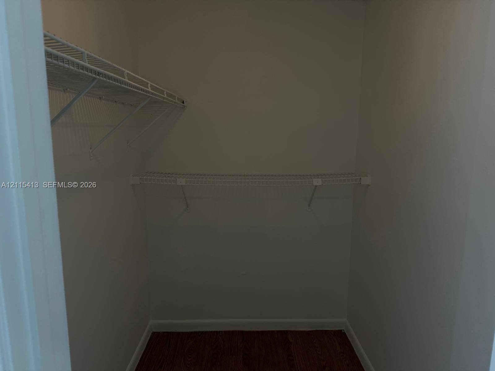 3001 NW 4th Terrace, #173, Pompano Beach, Pompano Beach, FL 33064 Reach-in closet featuring tiered wire shelving and wood-finish flooring