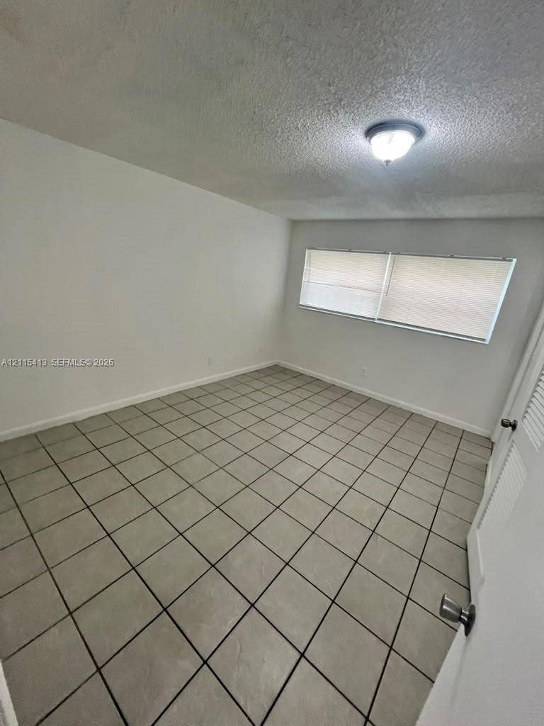 3001 NW 4th Terrace, #173, Pompano Beach, Pompano Beach, FL 33064 Neutral-toned ceramic tile flooring, semi-flush mount ceiling lighting, and horizontal window blinds