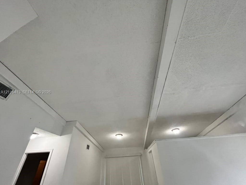 3001 NW 4th Terrace, #173, Pompano Beach, Pompano Beach, FL 33064 White textured ceiling featuring exposed structural beams and dual flush-mount light fixtures