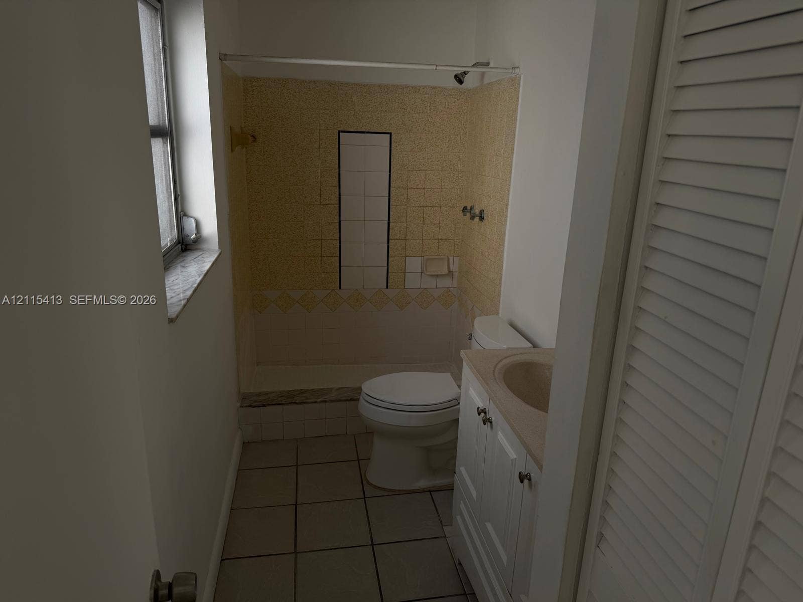 3001 NW 4th Terrace, #173, Pompano Beach, Pompano Beach, FL 33064 Bathroom featuring tiled floor, vanity with integrated sink, shower enclosure with tile surround, and louvered closet doors