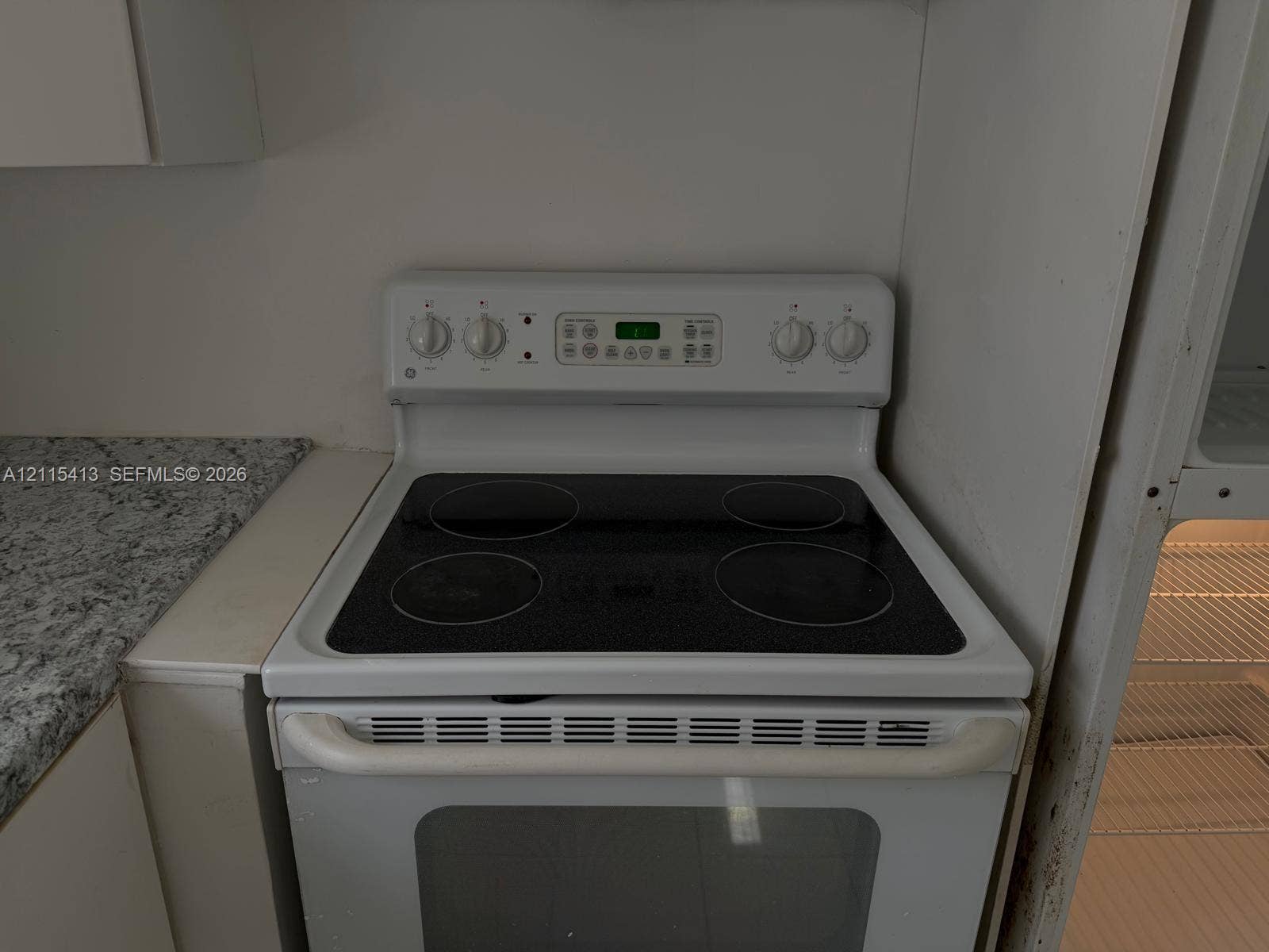 3001 NW 4th Terrace, #173, Pompano Beach, Pompano Beach, FL 33064 White electric range with a glass cooktop, digital control panel, and solid-surface countertop