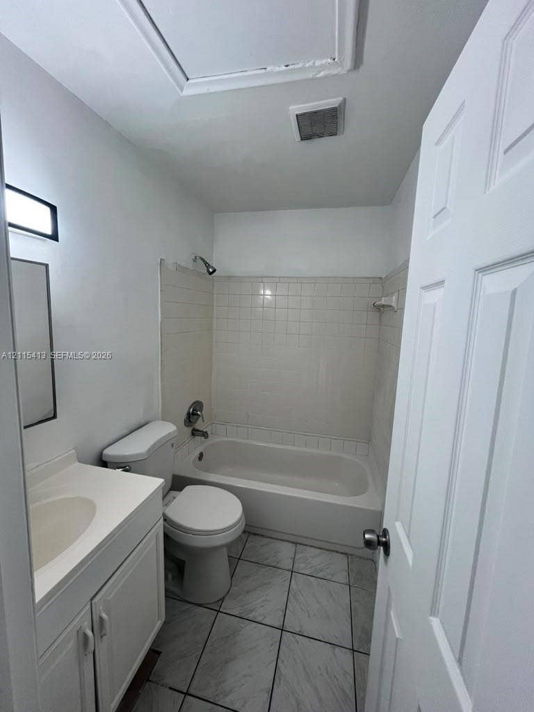 3001 NW 4th Terrace, #173, Pompano Beach, Pompano Beach, FL 33064 Bathroom featuring a vanity with an integrated sink, porcelain-tiled tub surround, a combination shower and soaking tub, and tile flooring