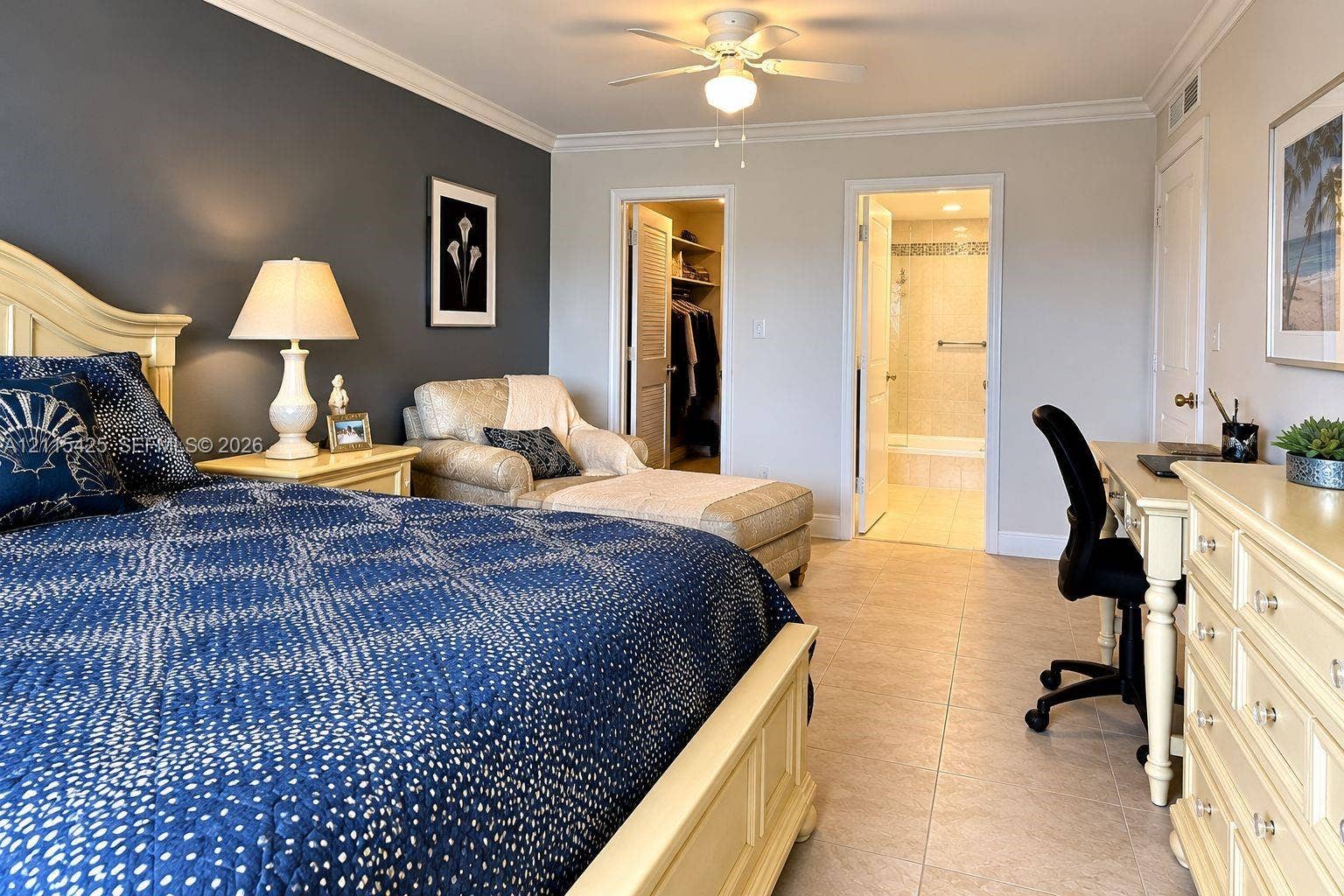 550 Bayshore Drive, #404, Fort Lauderdale, FL 33304 Room featuring an accent wall, tile flooring, crown molding, a ceiling fan, and a walk-in closet
