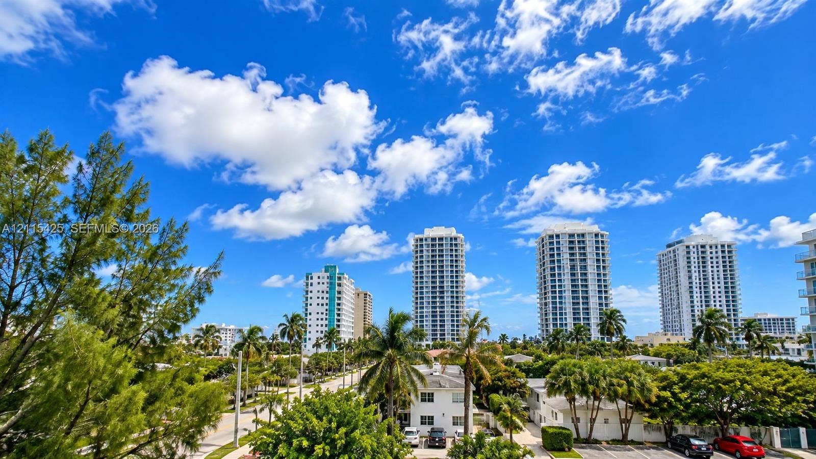 550 Bayshore Drive, #404, Fort Lauderdale, FL 33304 High-rise urban landscape featuring mature tropical vegetation, paved streets, and multi-story residential architecture