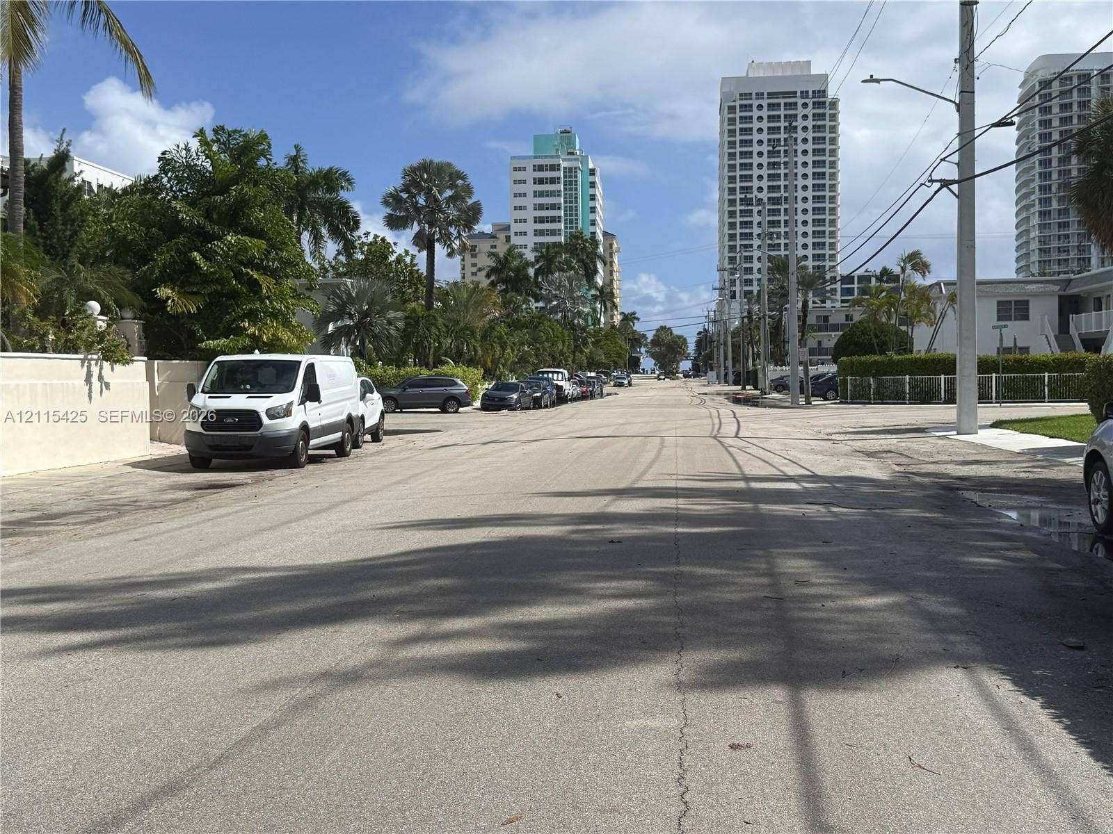 550 Bayshore Drive, #404, Fort Lauderdale, FL 33304 Paved public street bordered by mature palm trees, tropical landscaping, and high-rise structures