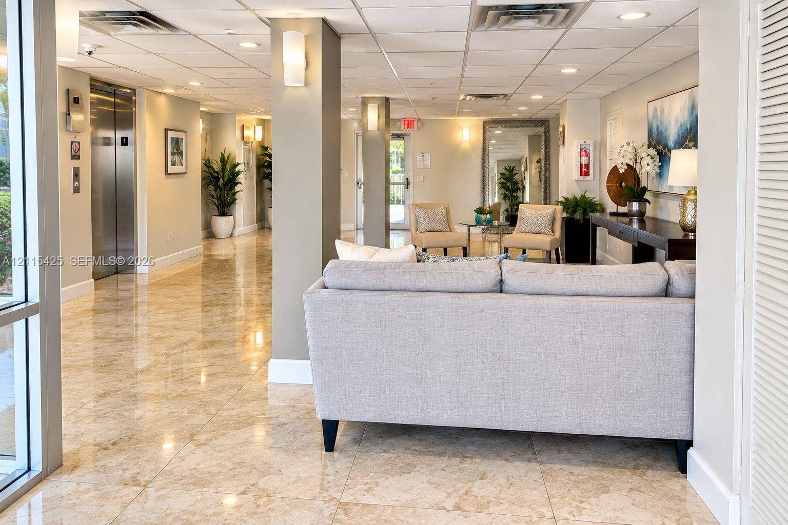 550 Bayshore Drive, #404, Fort Lauderdale, FL 33304 Lobby area featuring polished stone flooring, stainless steel elevator doors, recessed ceiling lighting, and wall-mounted sconces