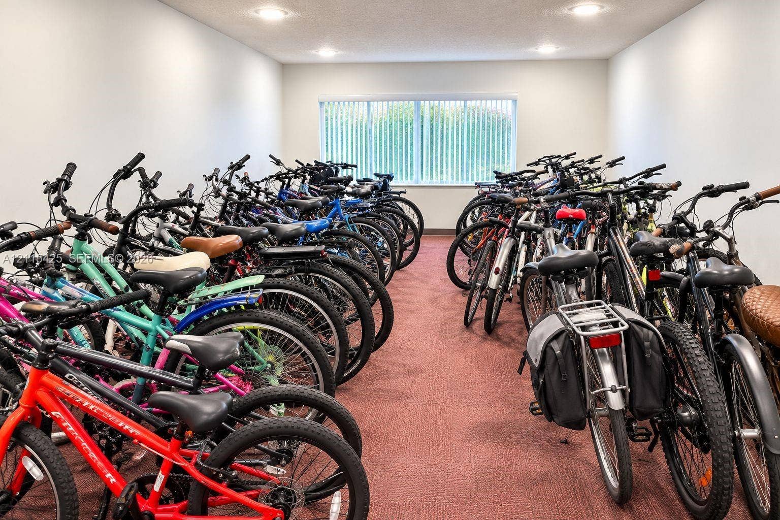 550 Bayshore Drive, #404, Fort Lauderdale, FL 33304 Enclosed storage room featuring neutral wall finishes, low-pile carpeting, recessed lighting, and a large window with vertical blinds