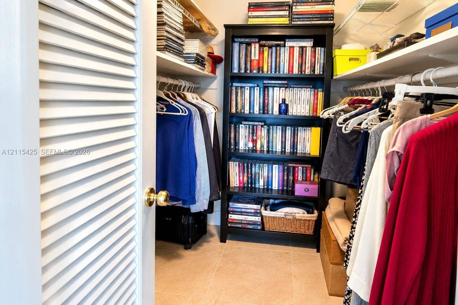 550 Bayshore Drive, #404, Fort Lauderdale, FL 33304 Storage area featuring louvered door access, white-coated wire shelving, and neutral-toned tile flooring
