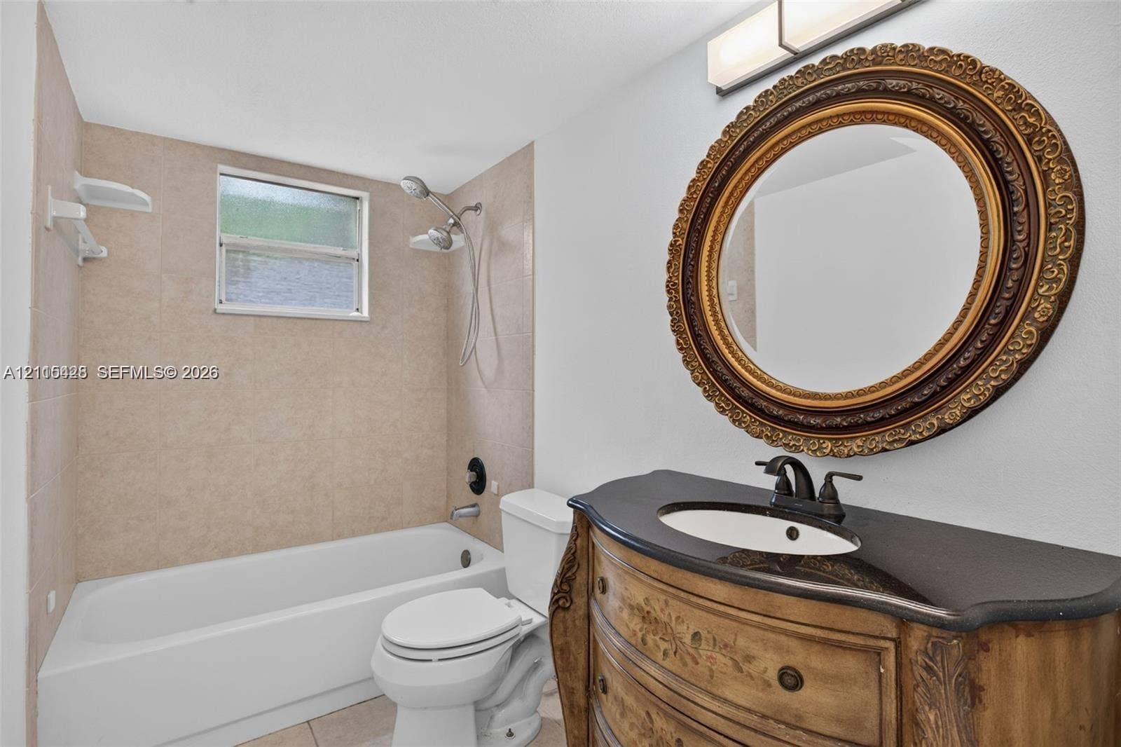 503 Gardens Drive, #201, Pompano Beach, Pompano Beach, FL 33069 Bathroom featuring a built-in vanity with a stone countertop, an integrated sink with a multi-handle faucet, a shower-tub combination with tile surround, and a wall-mounted light fixture