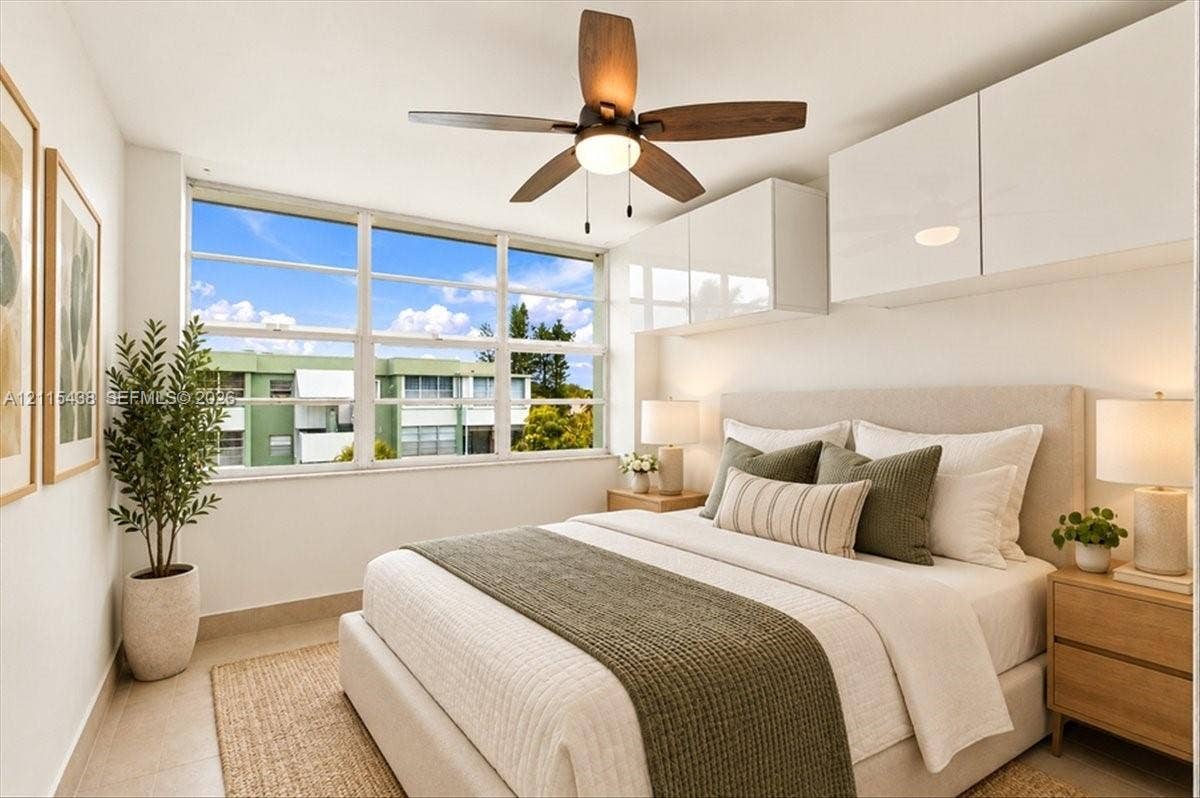 Large-pane horizontal windows, white high-gloss wall-mounted cabinetry, and a central ceiling fan with integrated lighting