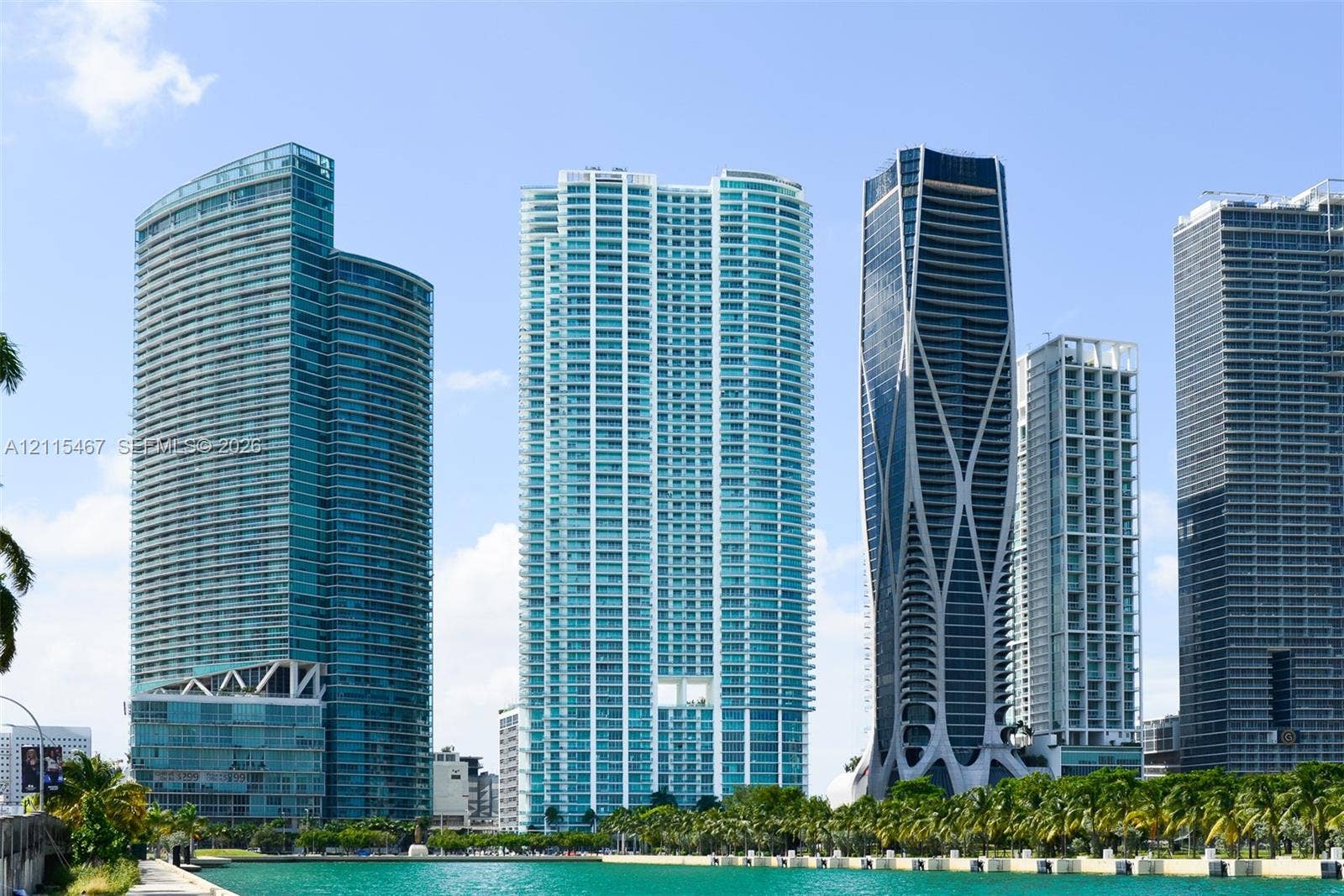 900 Biscayne Boulevard, #2104, Miami, FL 33132 High-rise urban landscape featuring glass-facade skyscrapers, curvilinear architectural designs, and water-front proximity