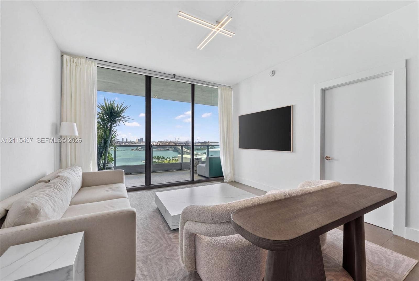 900 Biscayne Boulevard, #2104, Miami, FL 33132 Floor-to-ceiling windows, private balcony, linear geometric ceiling light fixture, and neutral wall-to-wall carpeting