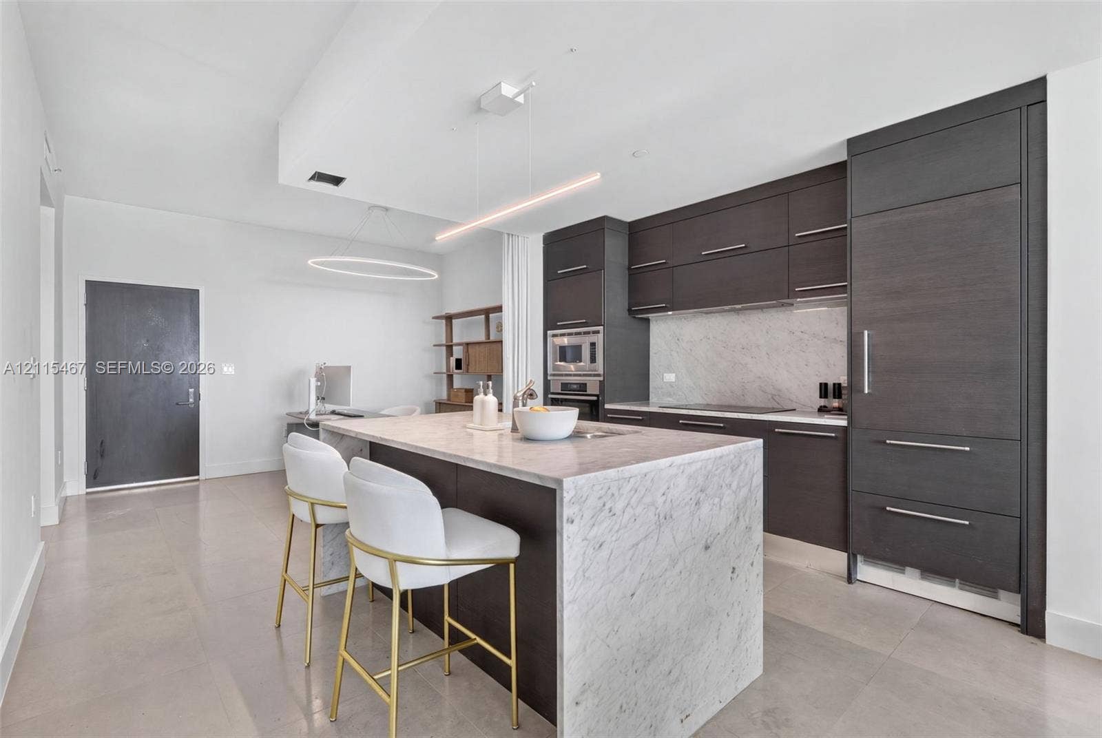 900 Biscayne Boulevard, #2104, Miami, FL 33132 Kitchen featuring flat-panel cabinetry, stone countertops with waterfall edge island, built-in panel-ready refrigerator, and linear pendant lighting