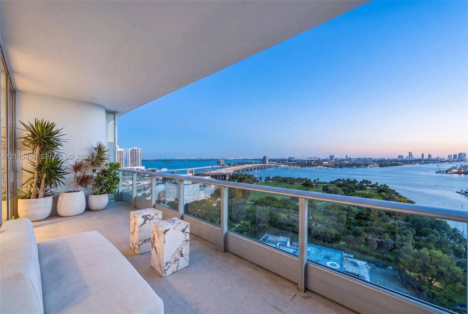 900 Biscayne Boulevard, #2104, Miami, FL 33132 Covered balcony with concrete flooring, glass railing, and expansive panoramic waterfront scenery