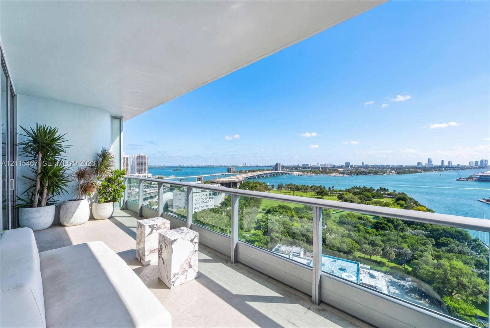 900 Biscayne Boulevard, #2104, Miami, FL 33132 Covered balcony featuring concrete flooring and a glass-paneled railing system with a metal frame
