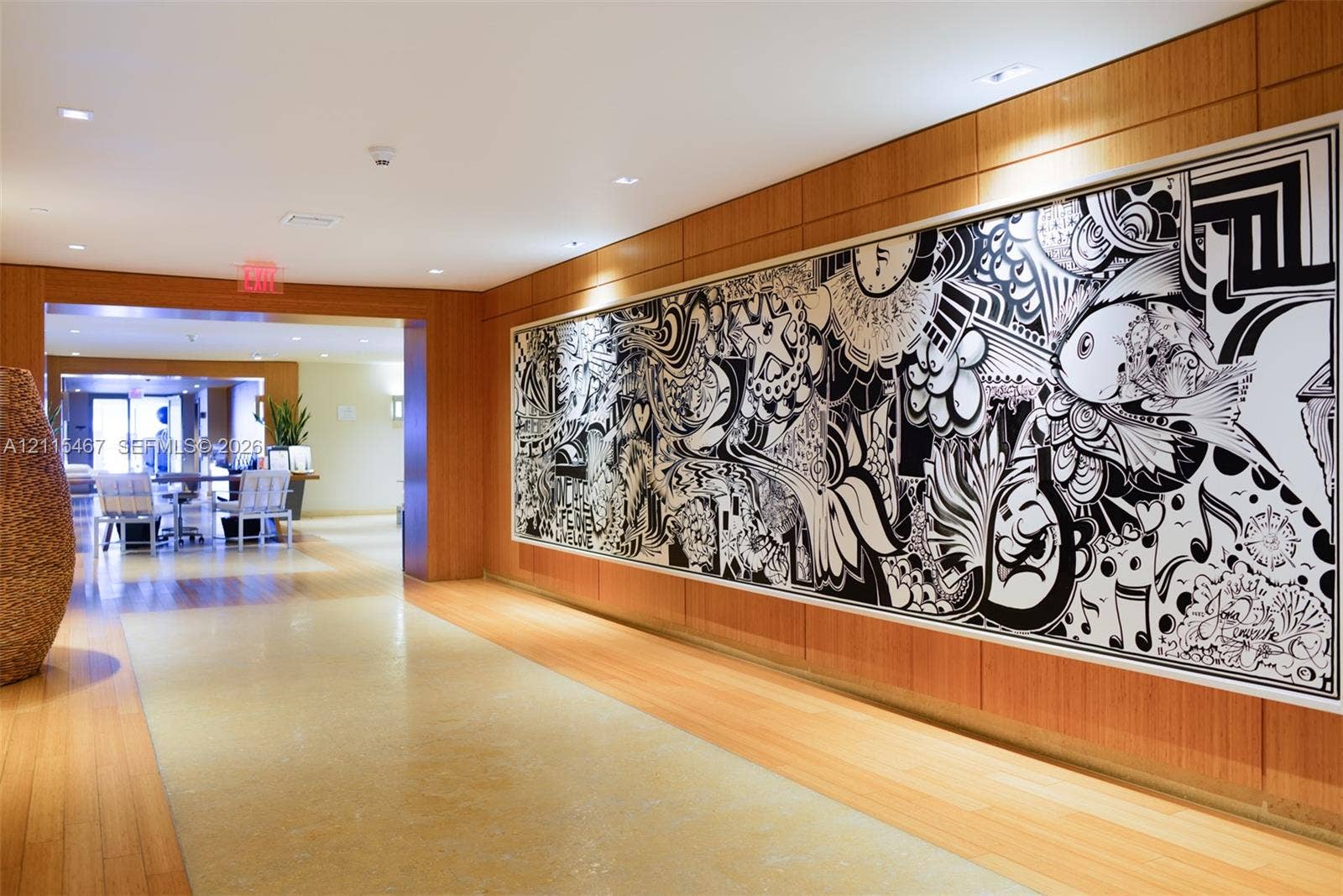 900 Biscayne Boulevard, #2104, Miami, FL 33132 Interior corridor featuring wood-paneled walls, recessed ceiling lighting, and polished stone flooring with wood-finish borders