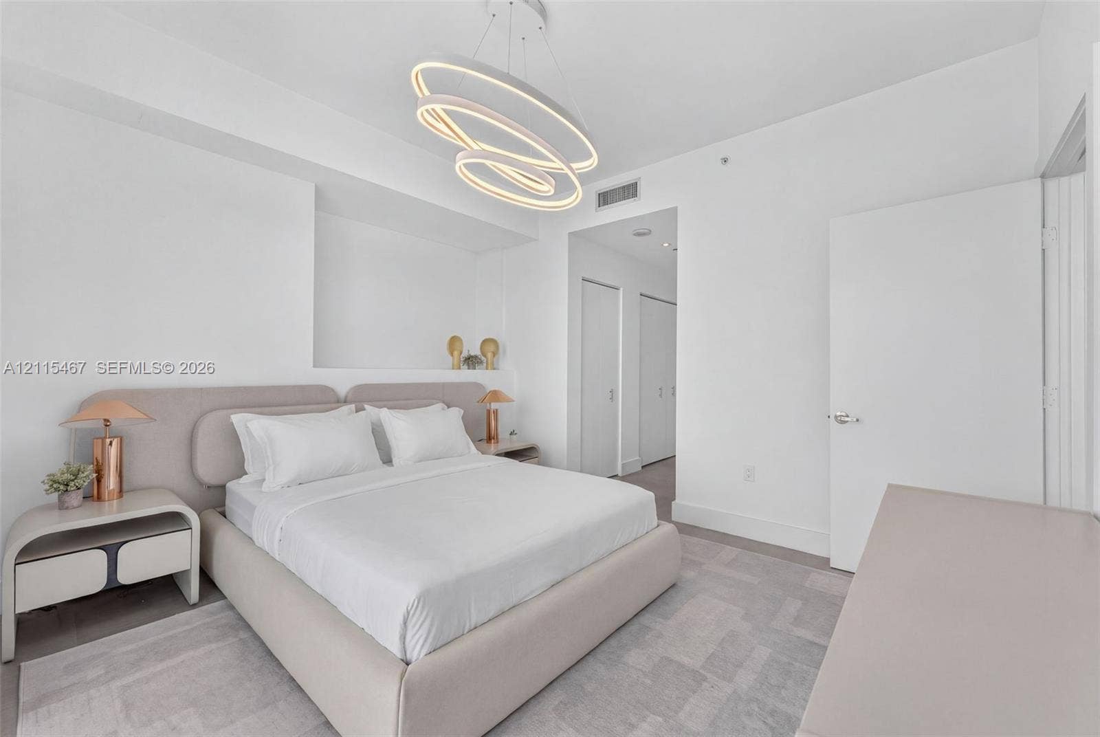 900 Biscayne Boulevard, #2104, Miami, FL 33132 Contemporary geometric LED chandelier, neutral wall-to-wall carpeting, and recessed wall niche with integrated shelving