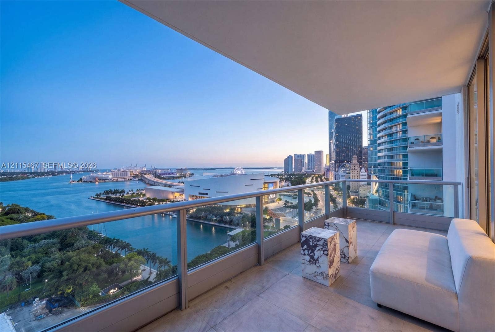 900 Biscayne Boulevard, #2104, Miami, FL 33132 Covered private balcony featuring large-format stone floor tiles and a minimalist glass-panel railing