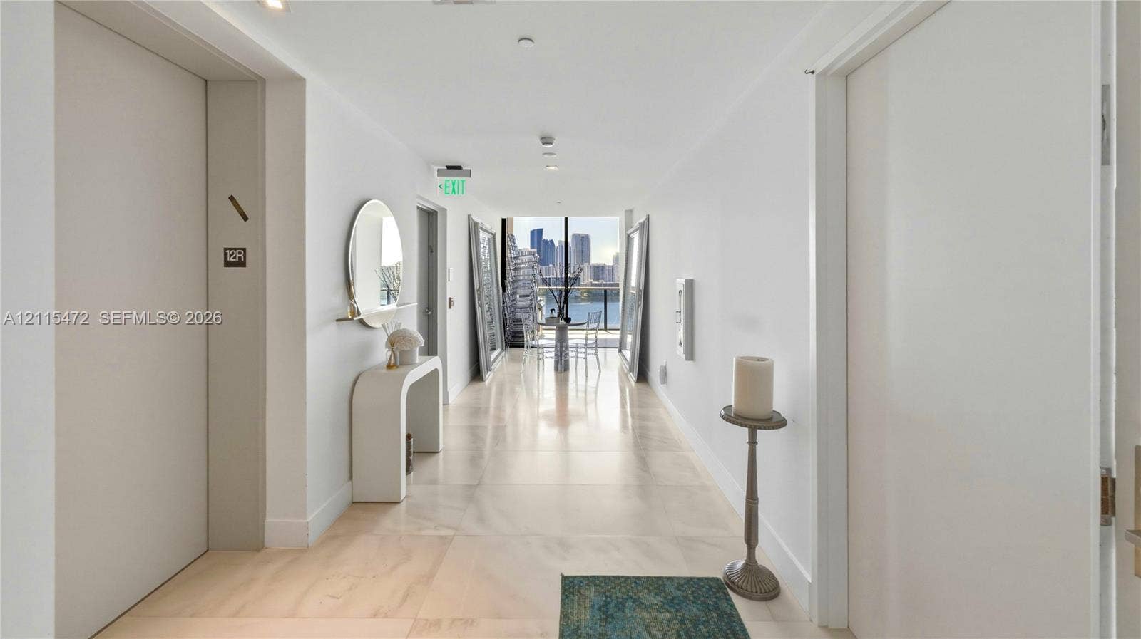 Foyer featuring polished stone flooring, recessed lighting, and a high-gloss finish throughout