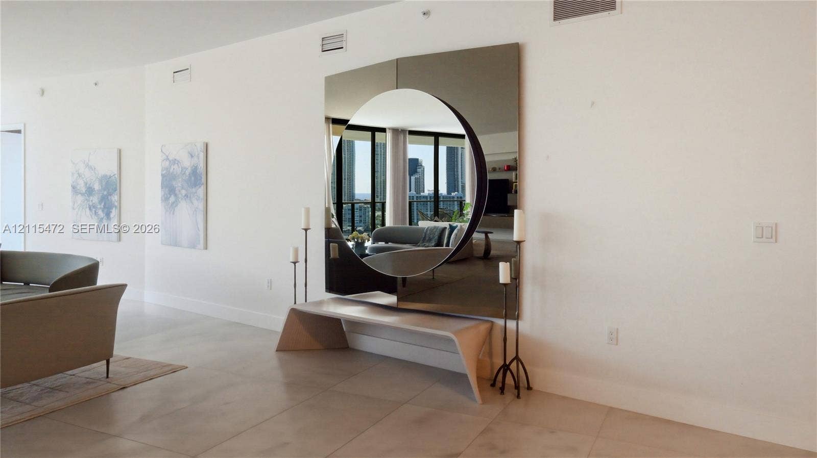 Large-format square wall mirror with a circular cutout and smooth-finish porcelain floor tiling