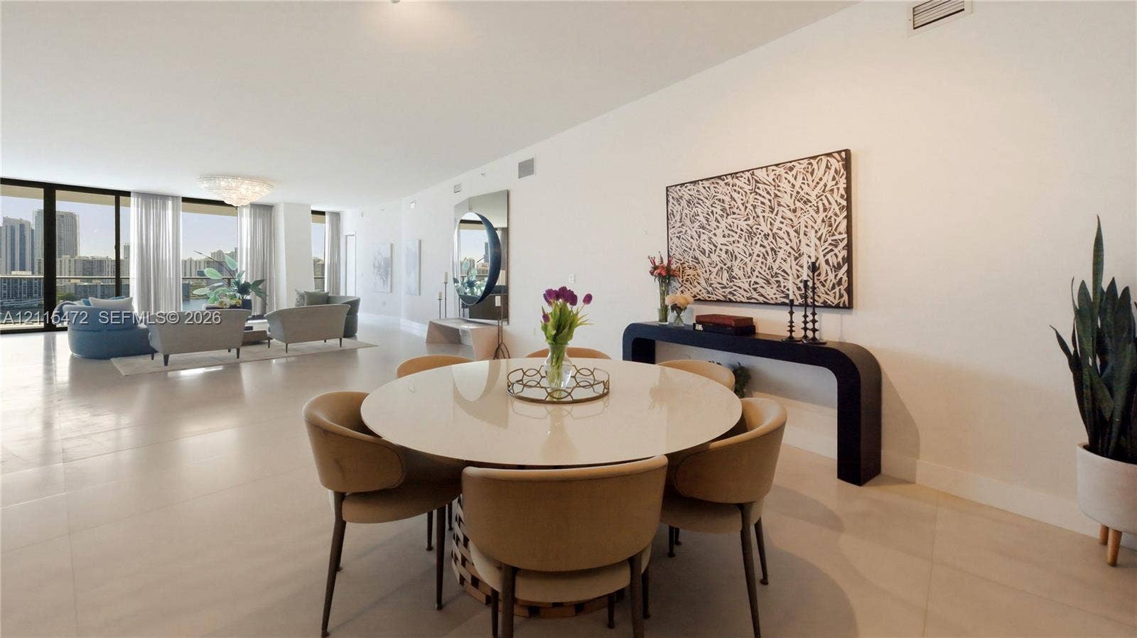 Open-concept floor plan featuring large-format tile flooring, floor-to-ceiling glass sliding doors, and neutral wall tones