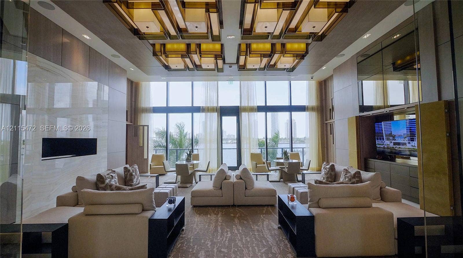Double-height floor-to-ceiling windows, custom geometric recessed ceiling lighting, linear wall-integrated fireplace with stone-finish surround, and built-in cabinetry