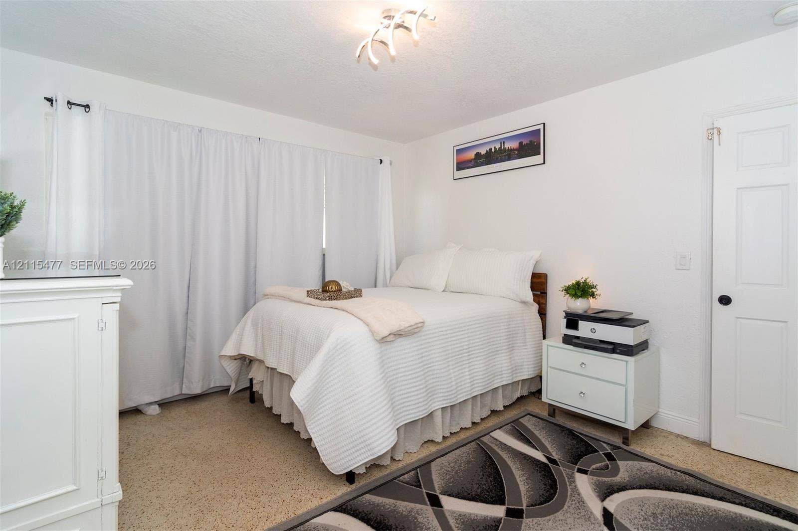 2510 NE 208th Terrace, Miami, FL 33180 Neutral-toned carpeting, ceiling-mounted decorative light fixture, and six-panel interior door