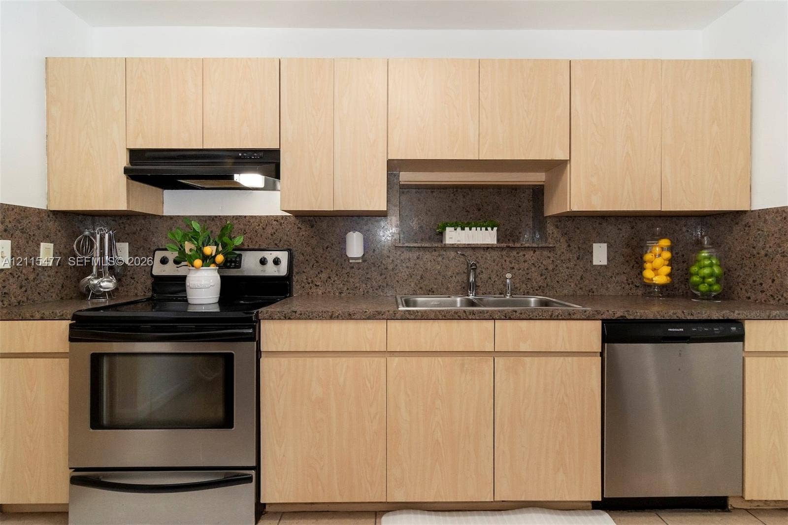 2510 NE 208th Terrace, Miami, FL 33180 Kitchen featuring light-finish cabinetry, solid surface countertops, a speckled stone backsplash, stainless steel dishwasher, and a stainless steel freestanding range