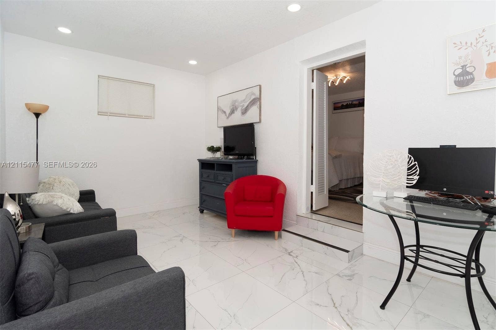 2510 NE 208th Terrace, Miami, FL 33180 Polished stone-finish flooring with neutral veining, recessed lighting, and a single-step entry featuring a threshold trim