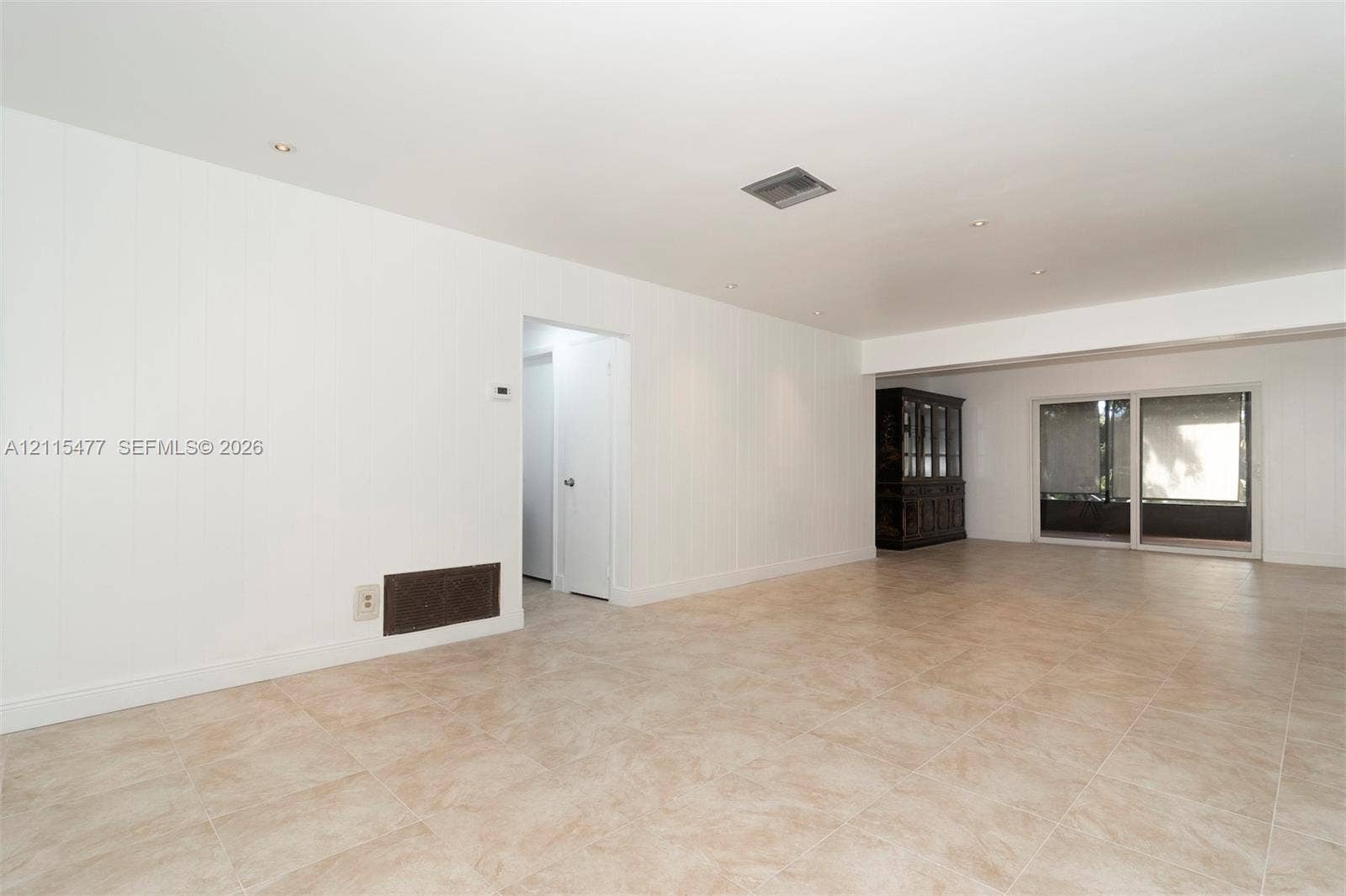 2510 NE 208th Terrace, Miami, FL 33180 Neutral interior featuring tile flooring, recessed lighting, and sliding glass doors