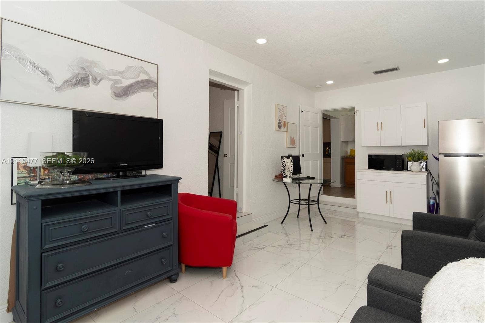 2510 NE 208th Terrace, Miami, FL 33180 Polished tile flooring, recessed ceiling lighting, and white built-in cabinetry featuring metallic hardware