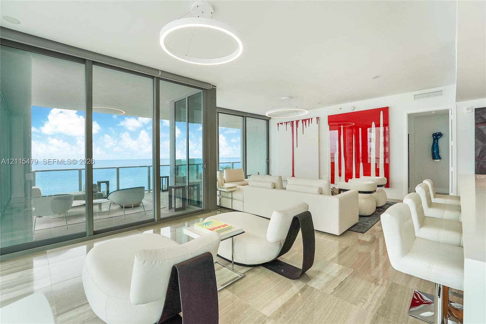 Floor-to-ceiling glass walls, polished stone flooring, circular LED light fixtures, and expansive private terrace