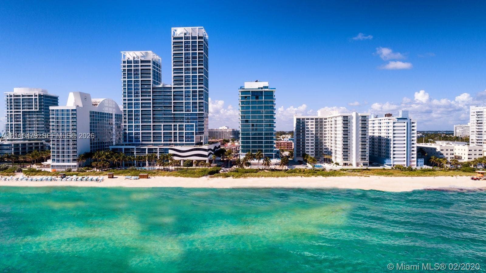 High-rise oceanfront architecture featuring expansive glass facades and immediate beach access