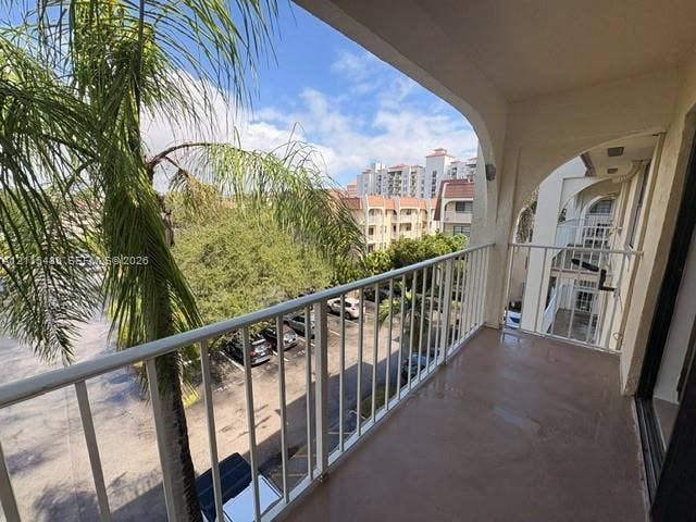 9301 SW 92nd Avenue, #A418, Miami, Miami, FL 33176 Covered balcony featuring white metal railings and arched architectural detailing