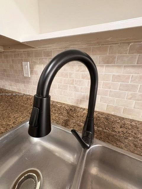 9301 SW 92nd Avenue, #A418, Miami, Miami, FL 33176 Matte black high-arc pull-down faucet, dual-basin stainless steel sink, stone-composite countertop, and brick-pattern tile backsplash