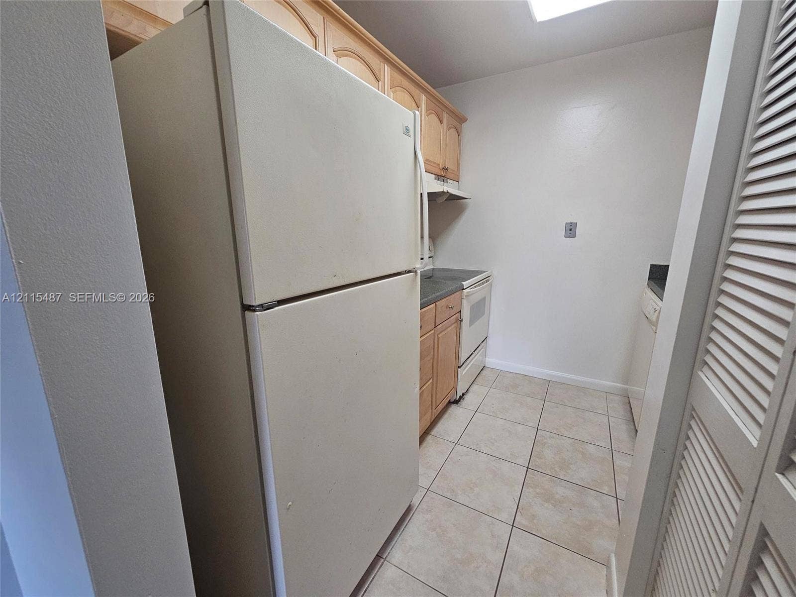 4279 NW 89th Avenue, #205, Coral Springs, Coral Springs, FL 33065 Kitchen featuring light wood cabinetry, tile flooring, and built-in appliances