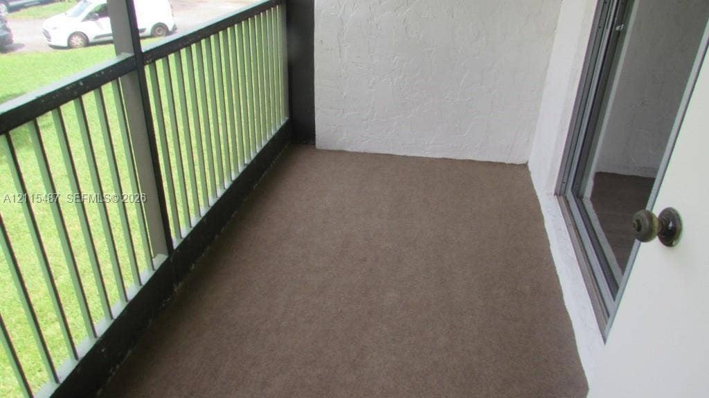 4279 NW 89th Avenue, #205, Coral Springs, Coral Springs, FL 33065 Covered balcony featuring textured walls, painted metal railing, and concrete flooring