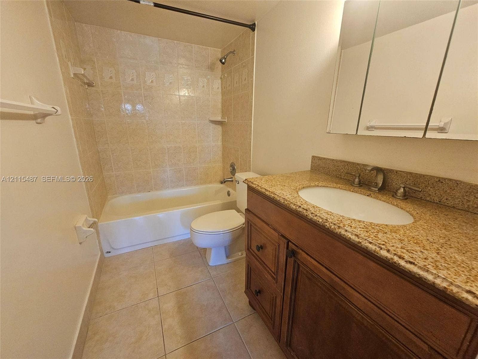 4279 NW 89th Avenue, #205, Coral Springs, Coral Springs, FL 33065 Bathroom featuring a wood vanity with stone-finish countertop, undermount sink, mirrored medicine cabinet, and a tiled tub-shower combination