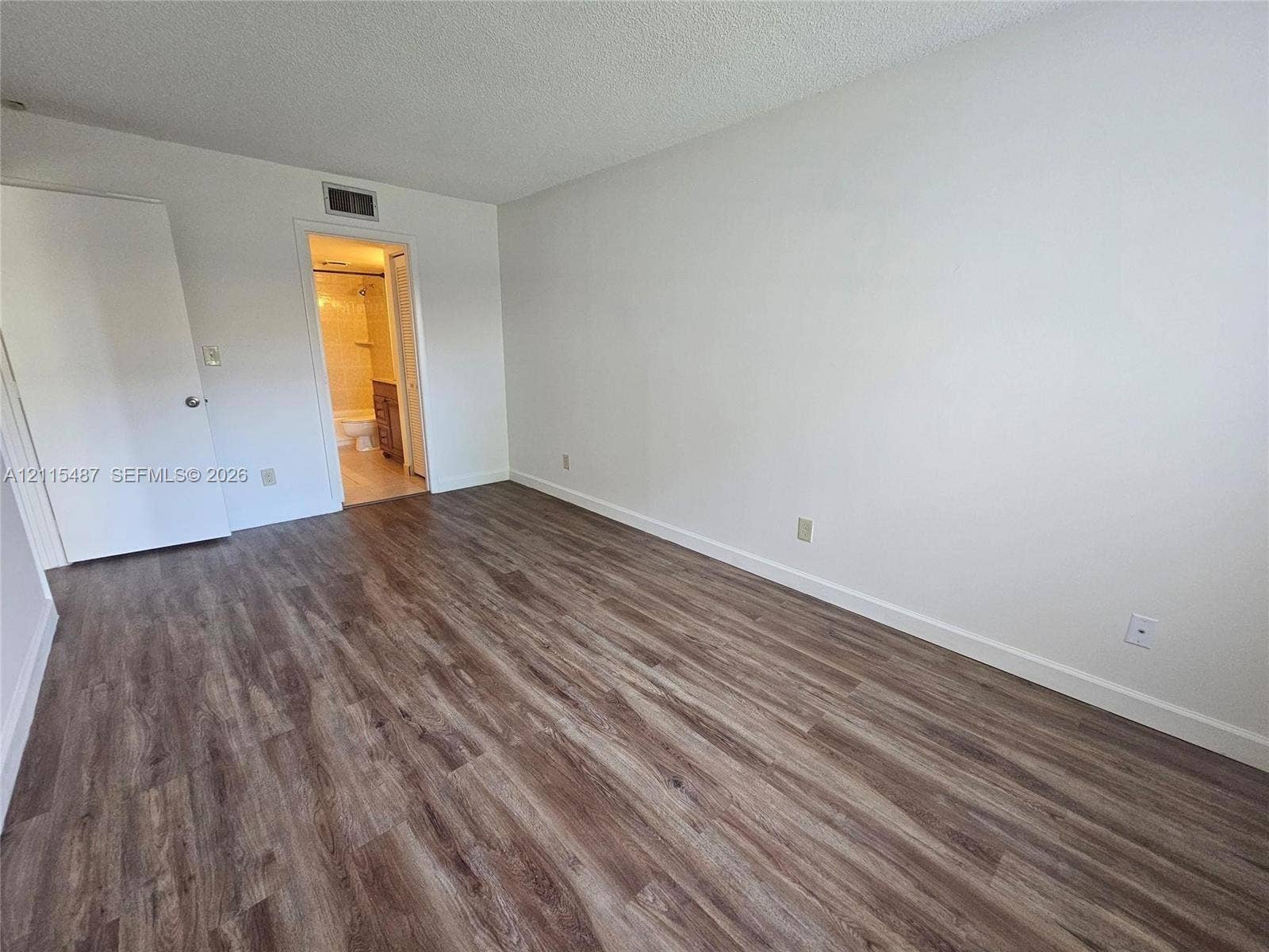 4279 NW 89th Avenue, #205, Coral Springs, Coral Springs, FL 33065 Room featuring wood-finish flooring and a neutral color palette