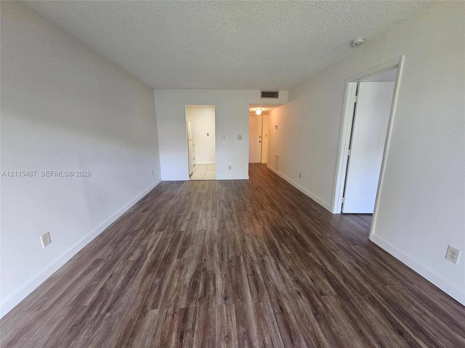 4279 NW 89th Avenue, #205, Coral Springs, Coral Springs, FL 33065 Interior area featuring wood-finish flooring and neutral-toned wall paint